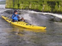 Sea kayak on the falls of Lora flood tide _Ken Lacey